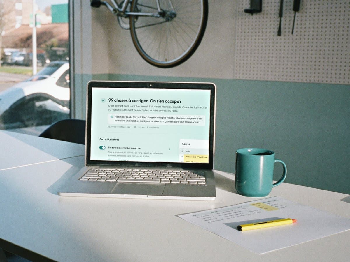 A small bike shop's back office: on the laptop, the report of a messy client list, 99 things to fix.